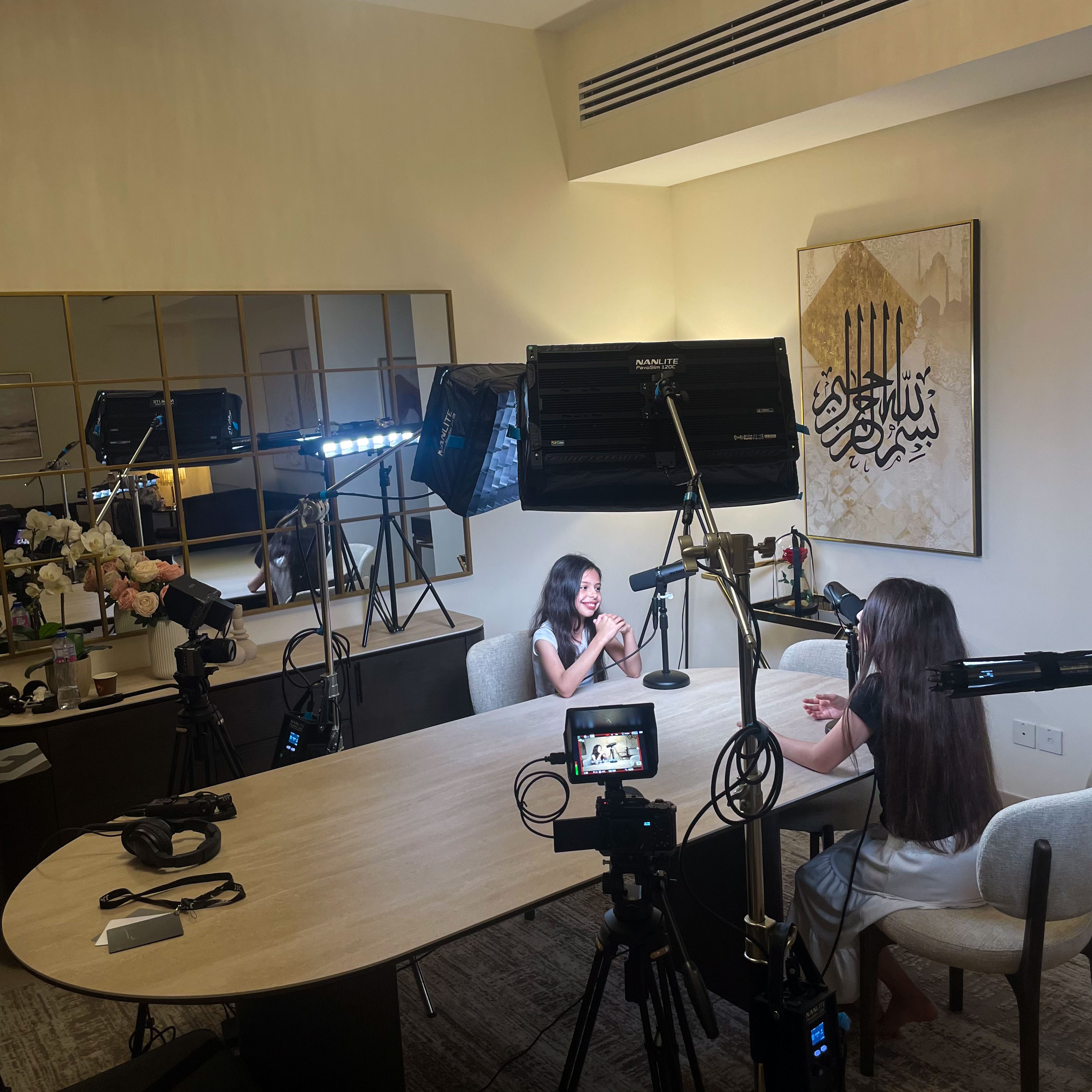 Three speakers recording a podcast around a circular table
